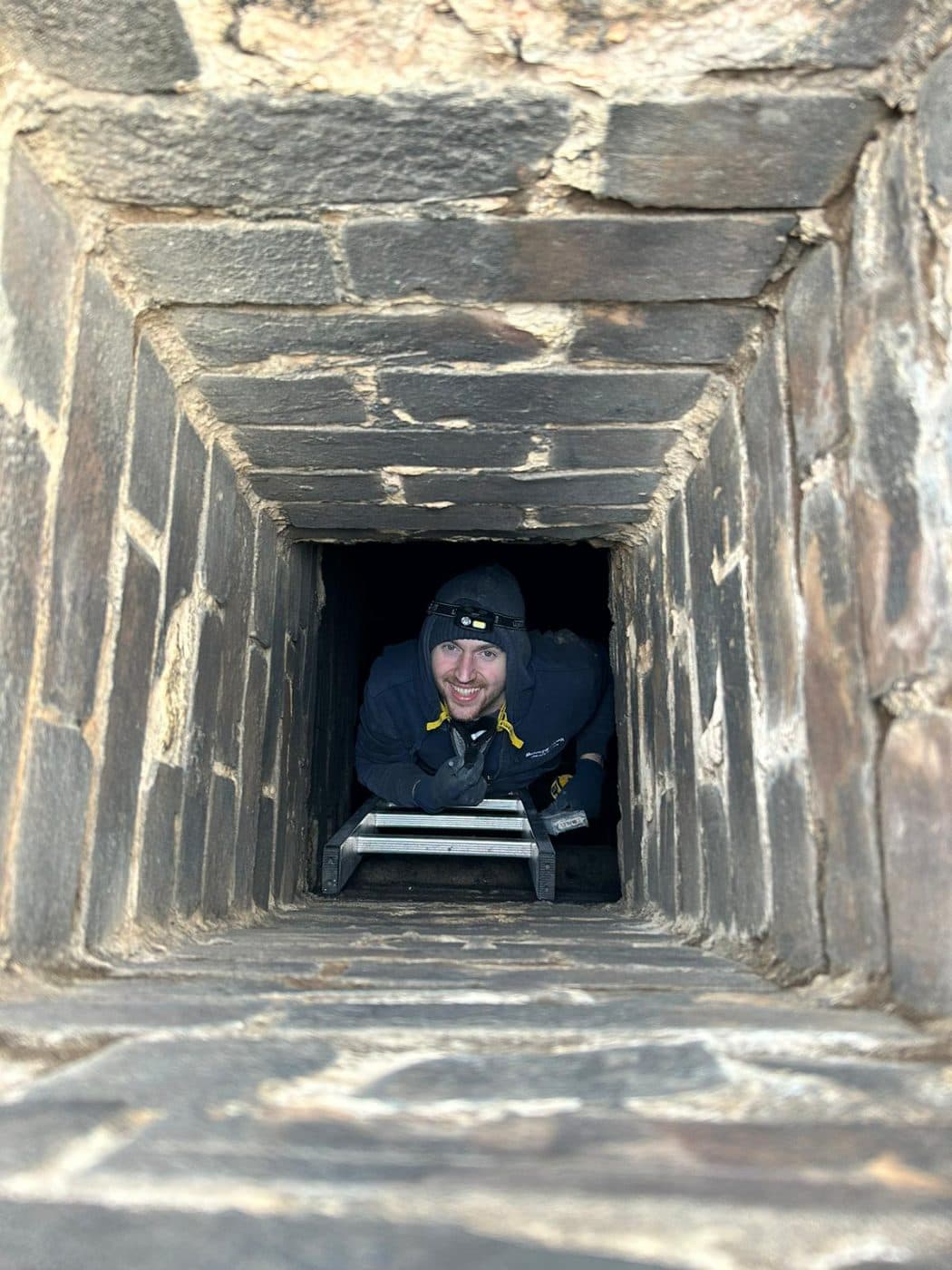 Ben in a chimney flue during a sweep